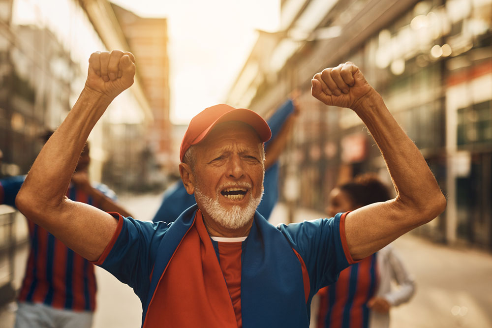 cheerful-senior-soccer-fan-cheering-on-the-street