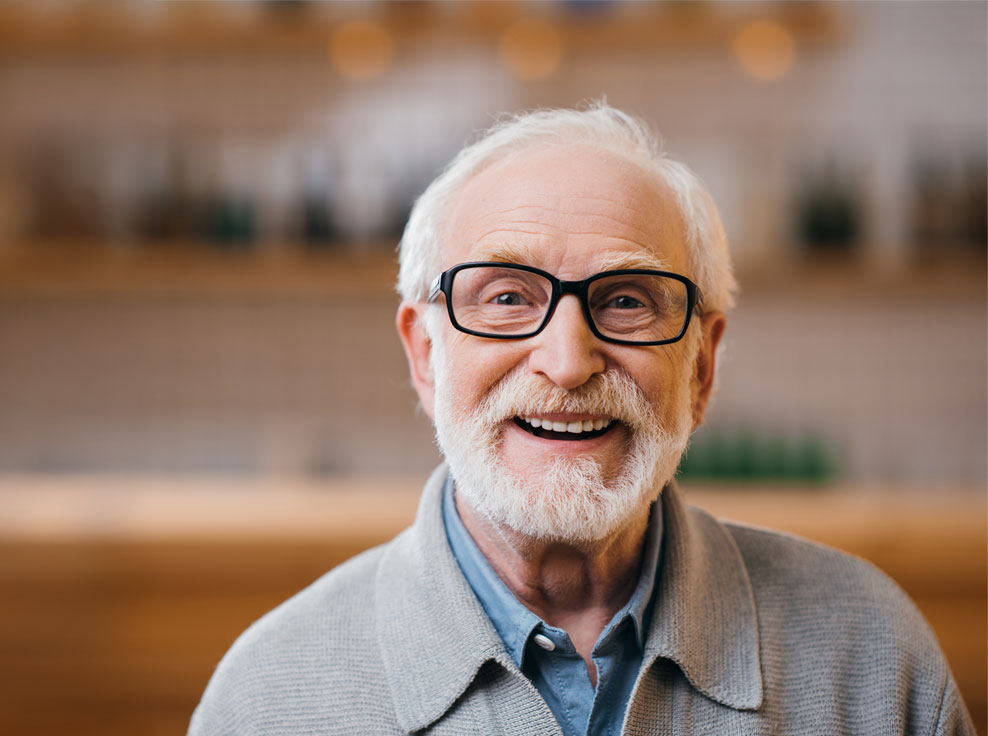 close-up-portrait-of-happy-senior-man-looking-at-c-mobile