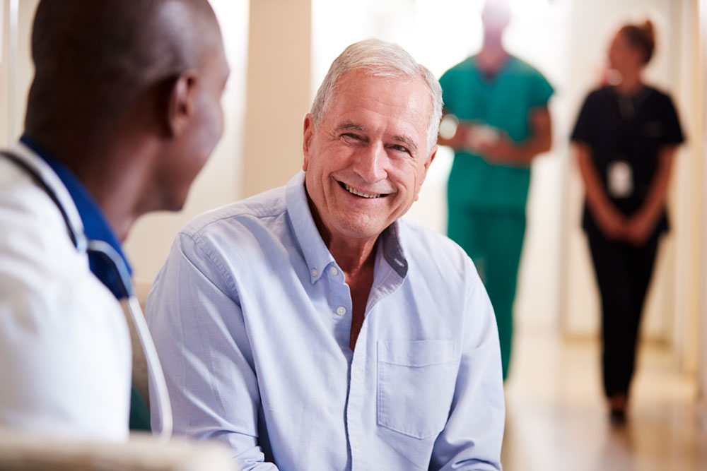 doctor-welcoming-to-senior-male-patient-being-admi-2024-10-19-10-55-59-utc